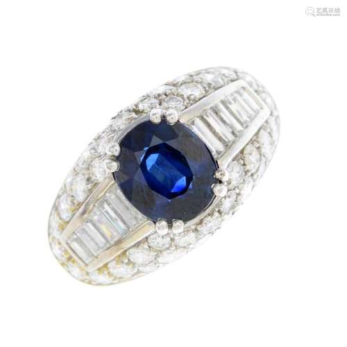 An 18ct gold sapphire and diamond dress ring. The