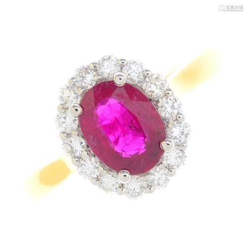 An 18ct gold ruby and diamond cluster ring. The