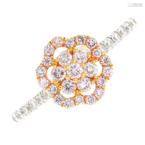An 18ct gold coloured diamond and diamond ring. Of