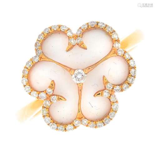An 18ct gold diamond and ceramic floral ring. The