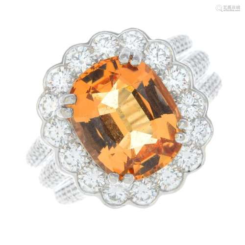 A platinum topaz and diamond cluster ring. The