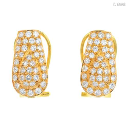 A pair of diamond earrings. Each designed as a pave-set