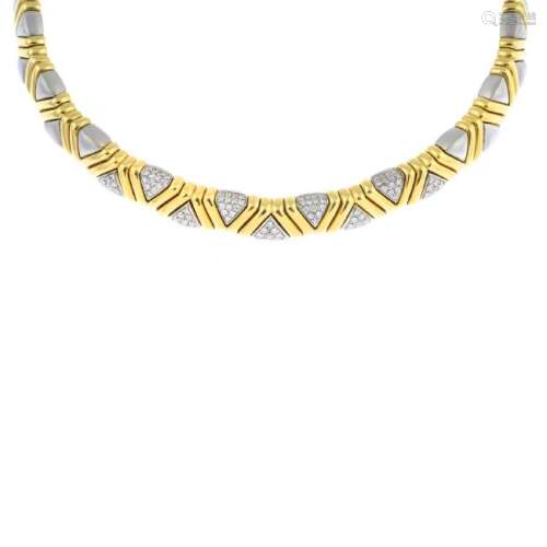 An 18ct gold diamond collar. Of bi-colour design,