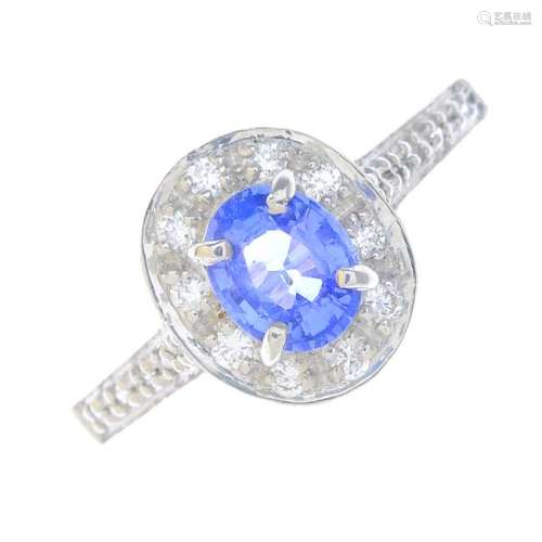 An 18ct gold sapphire and diamond cluster ring. The