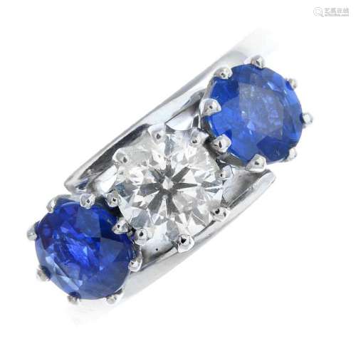 An 18ct gold sapphire and diamond three-stone ring. The