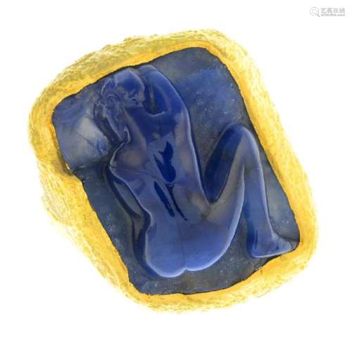 A sapphire ring. Of abstract design, the sapphire panel