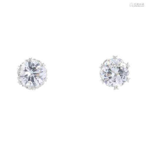 A pair of diamond stud earrings. Each designed as a
