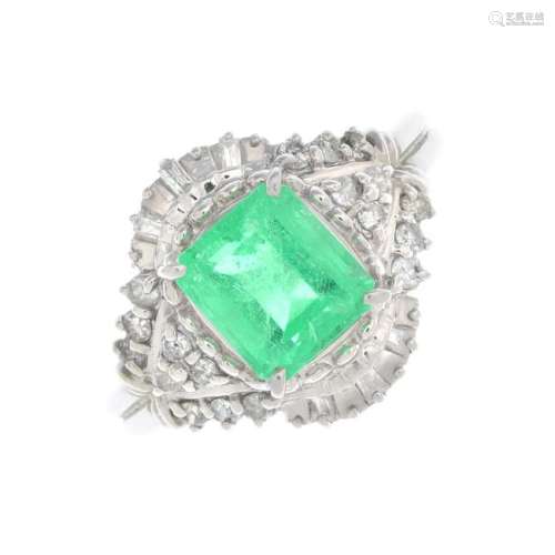 An emerald and diamond dress ring. The
