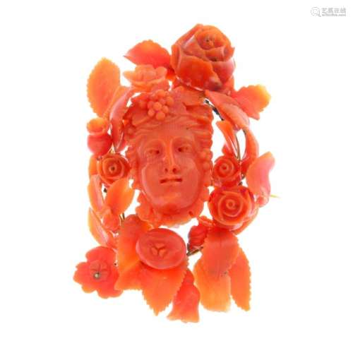 A mid 19th century coral brooch. Carved to depict