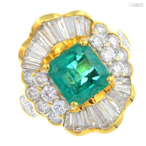 An emerald and diamond dress ring. The