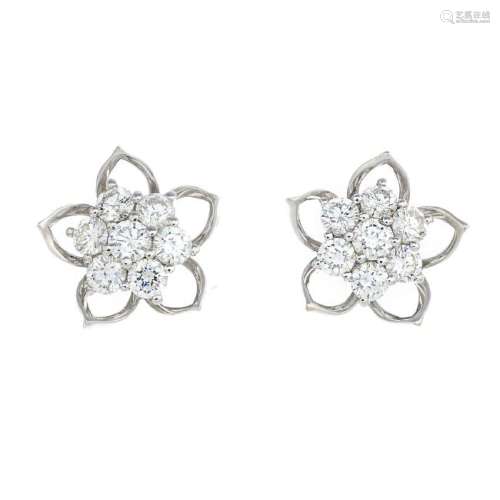 A pair of diamond earrings. Each designed as a