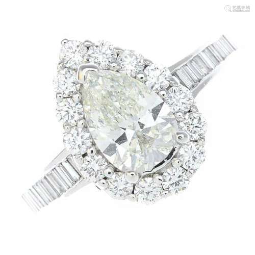 A diamond cluster ring. The pear-shape diamond, with