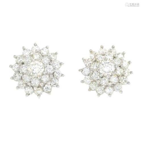 A pair of diamond cluster earrings. Each designed as a