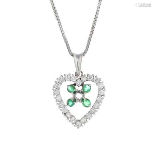 A diamond and emerald pendant. Designed as a