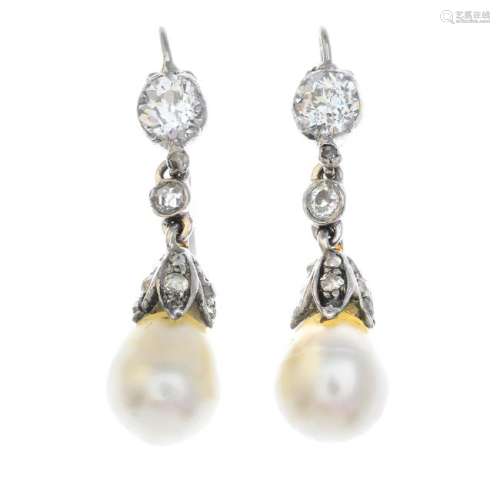 A pair of pearl and diamond earrings. Each designed as