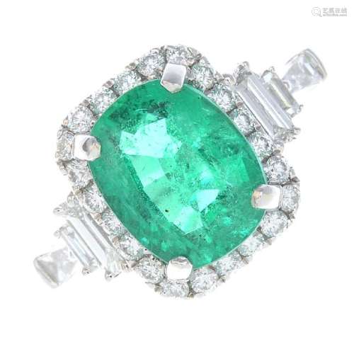 An emerald and diamond dress ring. The cushion-shape