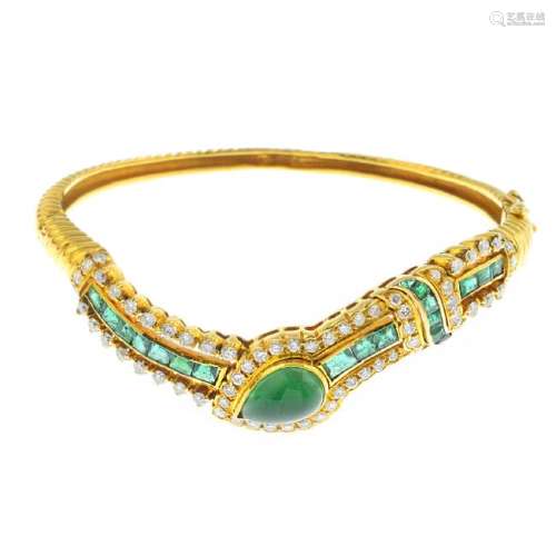 An emerald and diamond hinged bangle. Of asymmetric