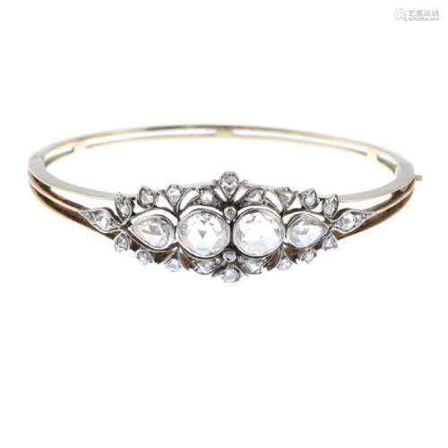 An Edwardian gold and silver, diamond hinged bangle. Of