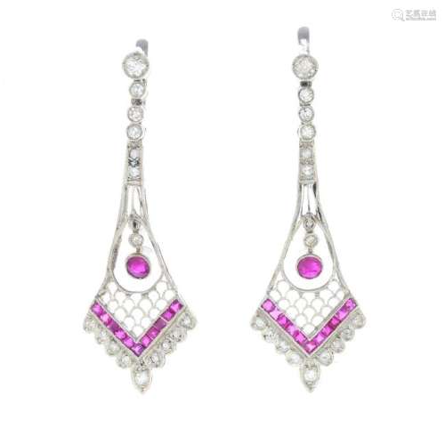 A pair of ruby and diamond earrings. Each designed as a