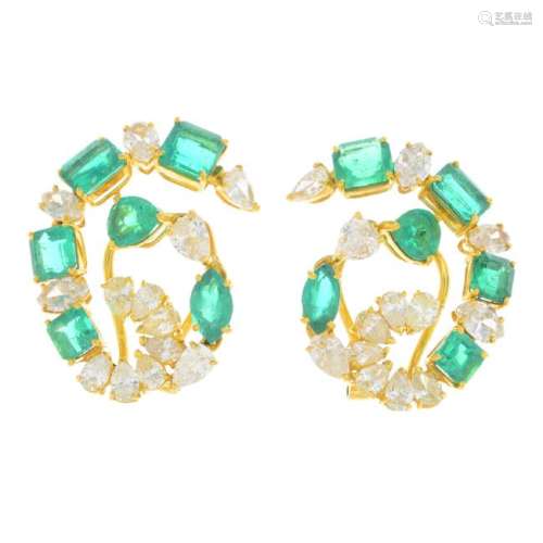 A pair of emerald and diamond clips. Each designed as a