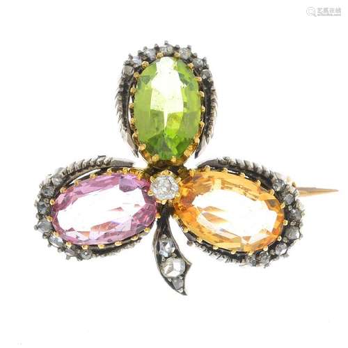 A diamond and gem-set brooch. Designed as a shamrock,