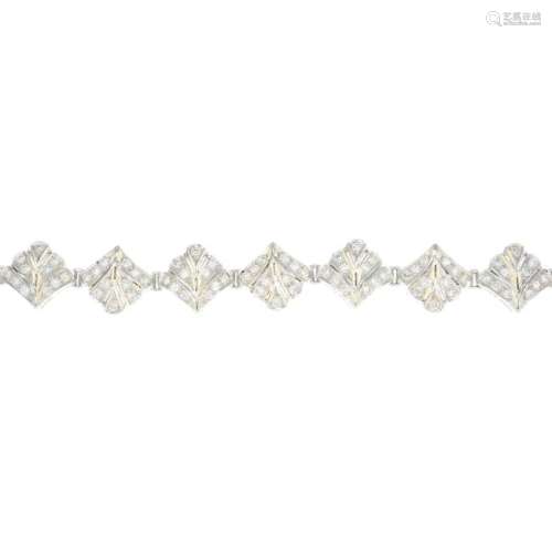 An 18ct gold diamond bracelet. Of openwork design,