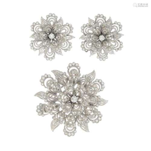 A diamond brooch and earrings. Each designed as an