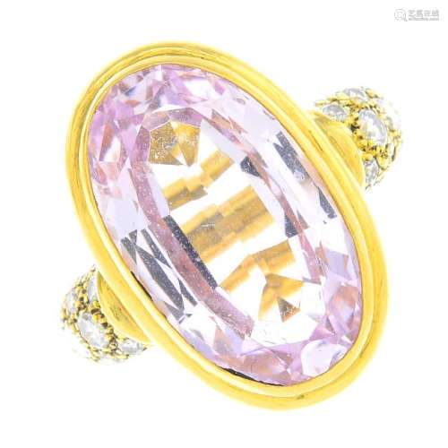 A topaz and diamond ring. The oval-shape pink topaz