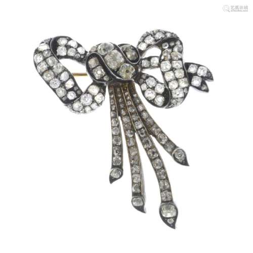 A late Victorian silver and gold diamond bow brooch.