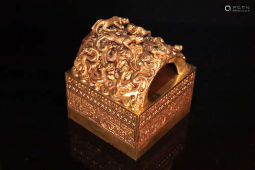 A GILT BRONZE MULTI DRAGON SHAPED SEAL