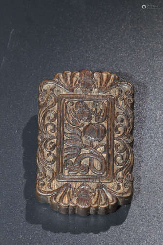 A CEHNXIANG WOOD CARVED WRAPPED LOTUS PENDANT