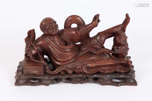 CARVED ASIAN FIGURINE of a JOLLY LOUNGING MAN