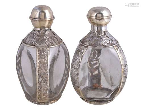 A pair of Mexican silver coloured and glass decanters