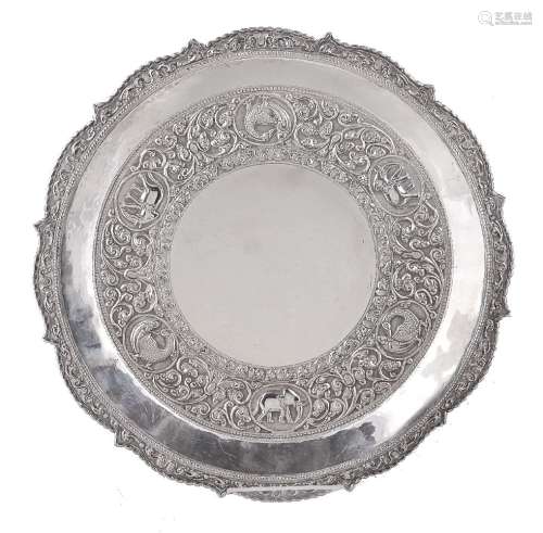 An Indian silver coloured shaped circular tray or salver