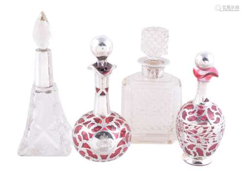 Four silver mounted glass scent or cologne bottles