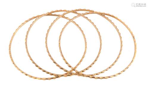 Four gold coloured bangles