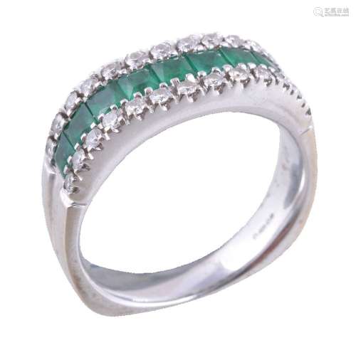 An 18 carat gold emerald and diamond ring