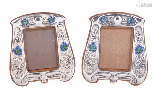 A pair of matched Arts and Crafts silver photograph frames