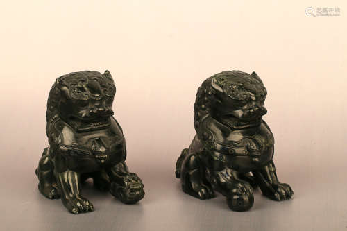 A PAIE OF LION DESIGN DARK GREEN JADE ORNAMENTS