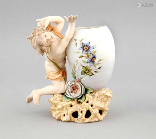 An ornamental vase in form of a putto playing with a