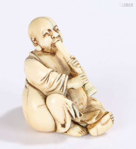 Japanese Meiji period ivory netsuke, carved as a figure playing an instrument, 5cm high