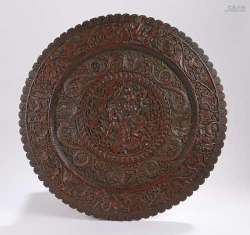 Hardwood plaque, the central field carved with a depiction of two deities surrounded by dragons,