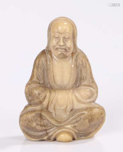 Chinese soap stone figure of a scholar, the robed seated figure with arms crossed within the robe,