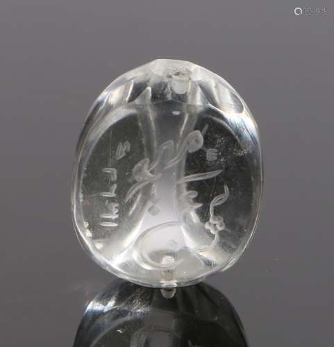 Islamic rock crystal seal, with script to the head with a hole through the centre