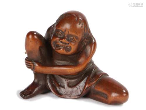 Japanese Edo period netsuke, the wood netsuke depicting a man with agonised expression as a bug