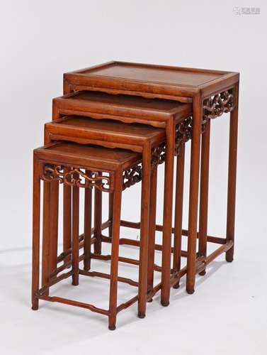 Nest of four Canton Chinese tables, with scroll pierced friezes, on turned legs and stretchers,