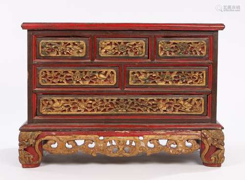 Chinese table top cabinet, in red and heightened in gilt, the rectangular top above six drawers