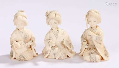 Japanese Meiji period ivory Okimono, the three figures as musicians crouched, each signed to the