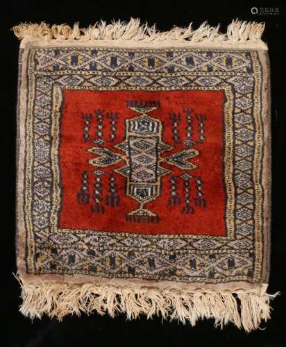 Miniature Persian rug, with a red ground and central medallion, 32cm x 30cm