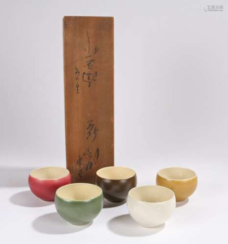 Set of five Chinese porcelain rice bowls, with white, yellow, red, brown and green exteriors, housed